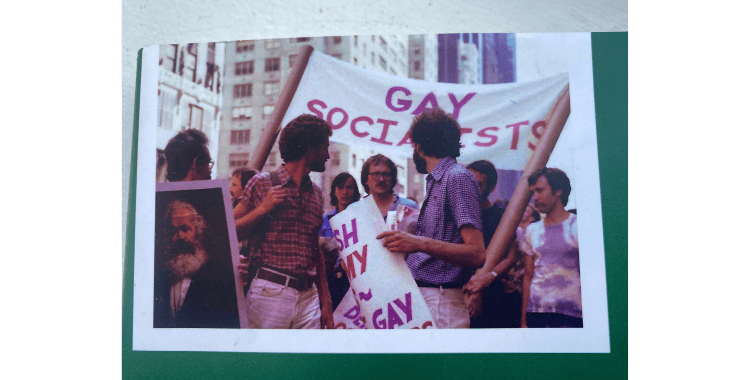 image of protesters holding a sign that reads gay socialists